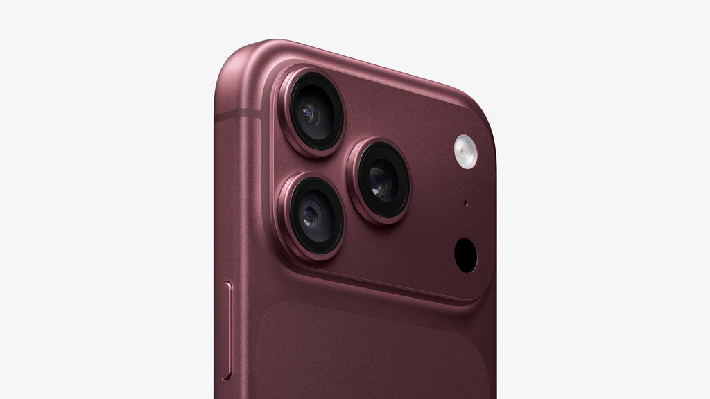 Close-up of the rear upper portion of a smartphone in a metallic rose-gold finish, showing three rear cameras, a flash, and a small circular cutout on a light gray background.