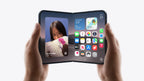 A black foldable smartphone held open in two hands against a clean white background, displaying its software interface on the screens.